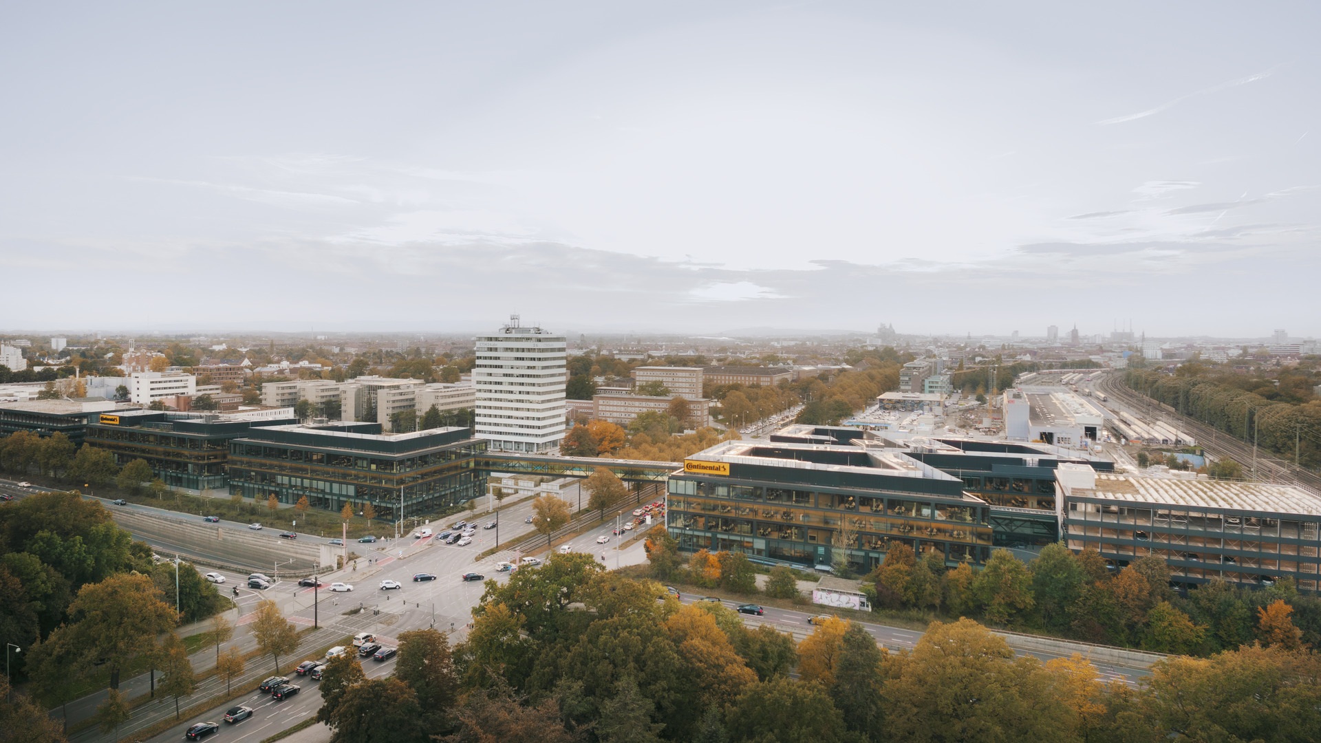 Luftaufnahme von innovativen Hightech-Gebäuden, präzisen Straßen und nachhaltigen Grünflächen in einem modernen städtischen Forschungsviertel.